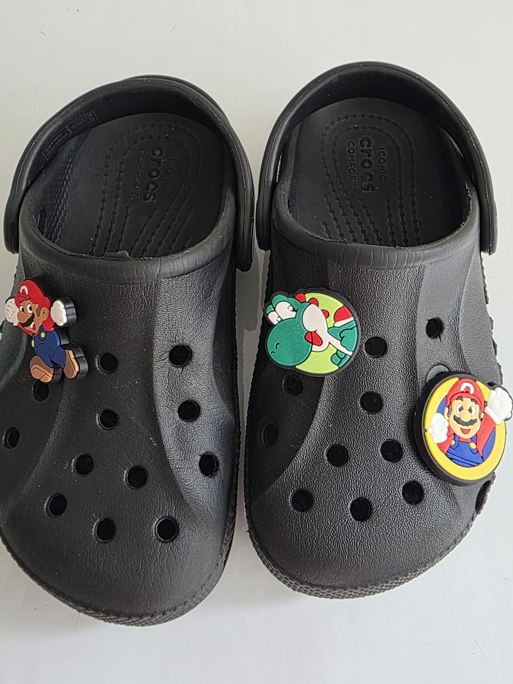 Crocs Kids Classic Clog in Black with Super Mario Charms.